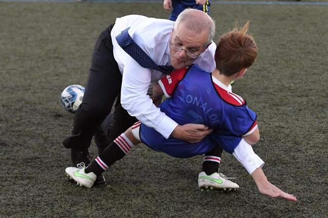 Strategic Australian President Rough Tackles Boy On Football Field For Election Promo